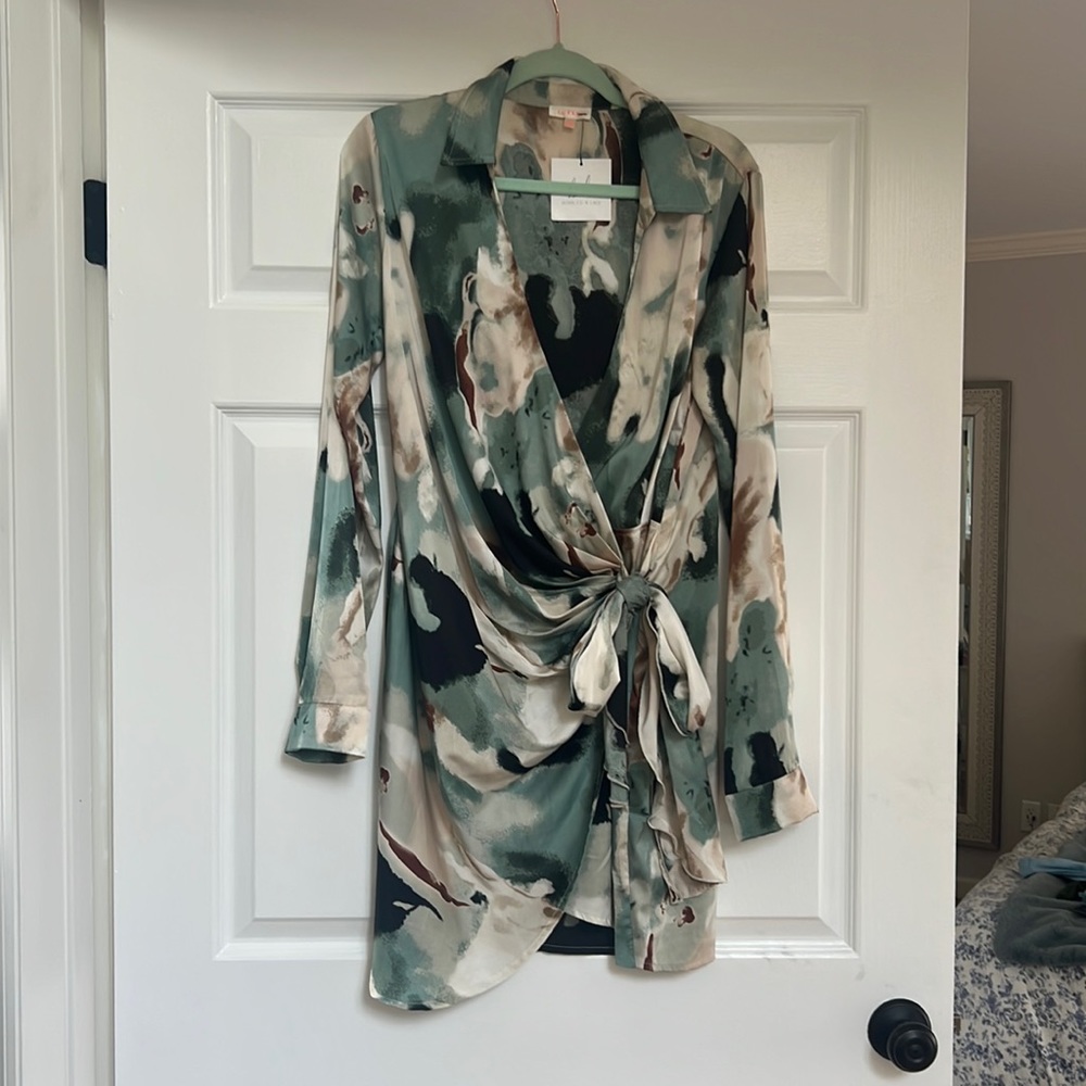 Collared long sleeve faux wrap dress in teal pattern. NWTO.